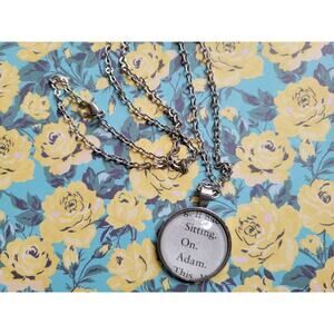 Sitting on Adam pendant necklace with from The Love Hypothesis book pages
